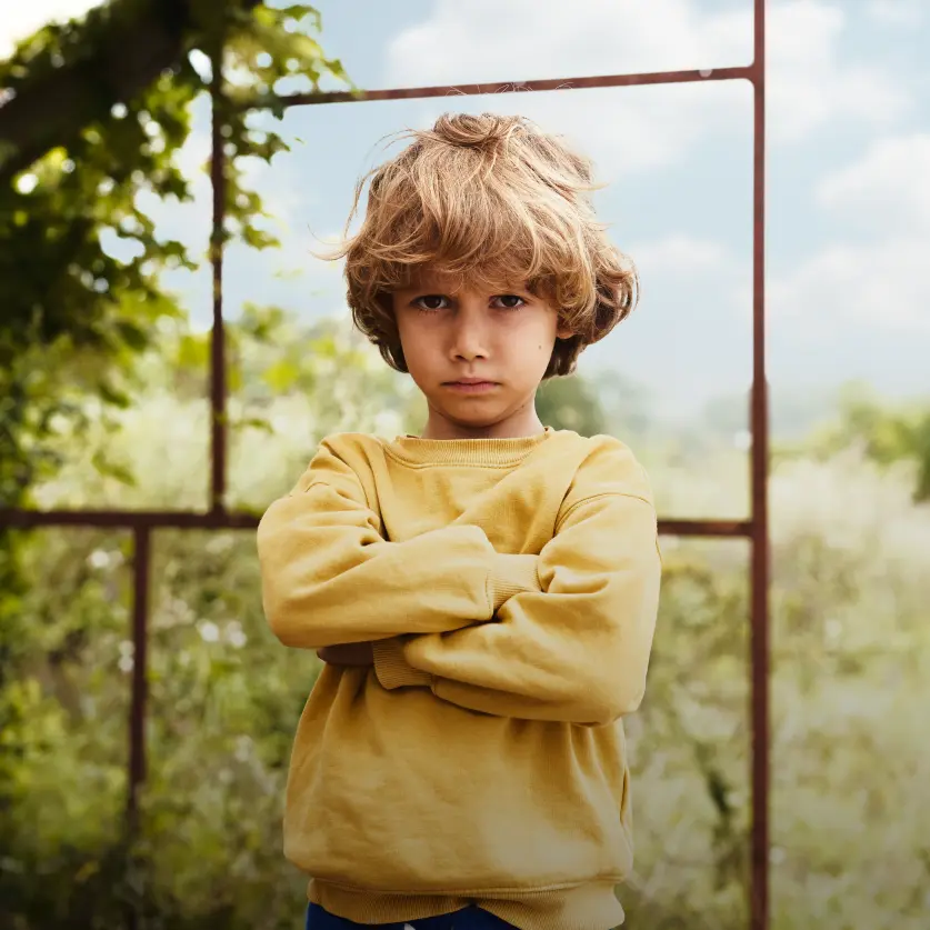 Ein kleiner Junge gut eingeschnappt und unzufrieden direkt in die Kamera.