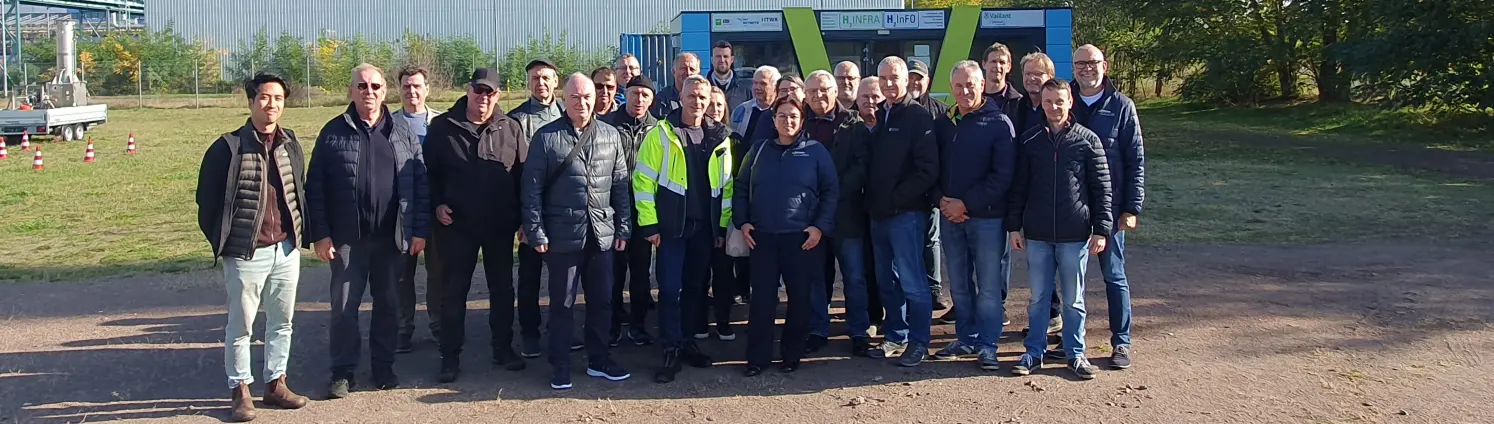 Marktpartner-Treffen der Energie Brandenburg 2024: Gruppenfoto der Teilnehmenden im Freien vor einer Werkhalle.