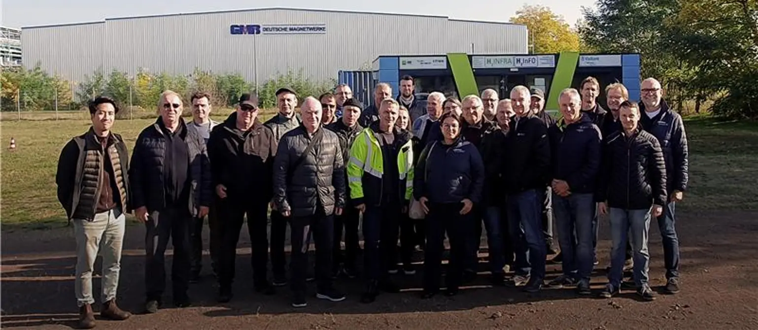 Marktpartner-Treffen der Energie Brandenburg 2024: Gruppenfoto der Teilnehmenden im Freien vor einer Werkhalle.