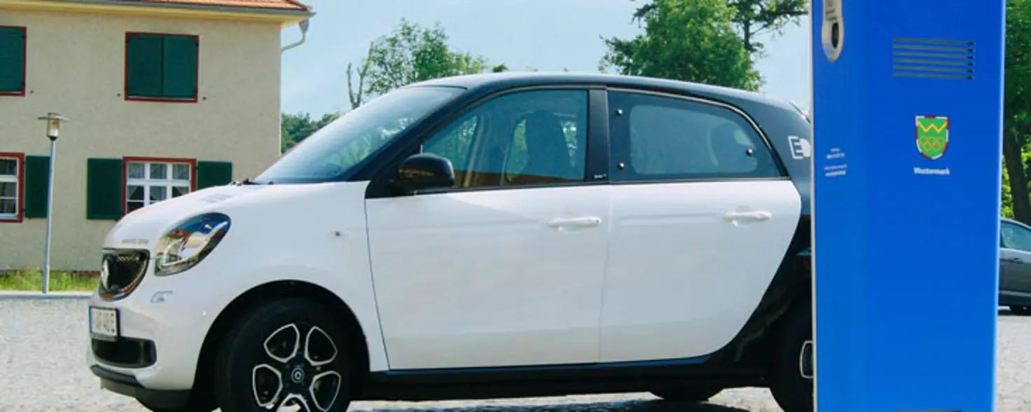 Ein Elektro-Kleinwagen lädt an einer Schnellladesäule der Energie Brandenburg