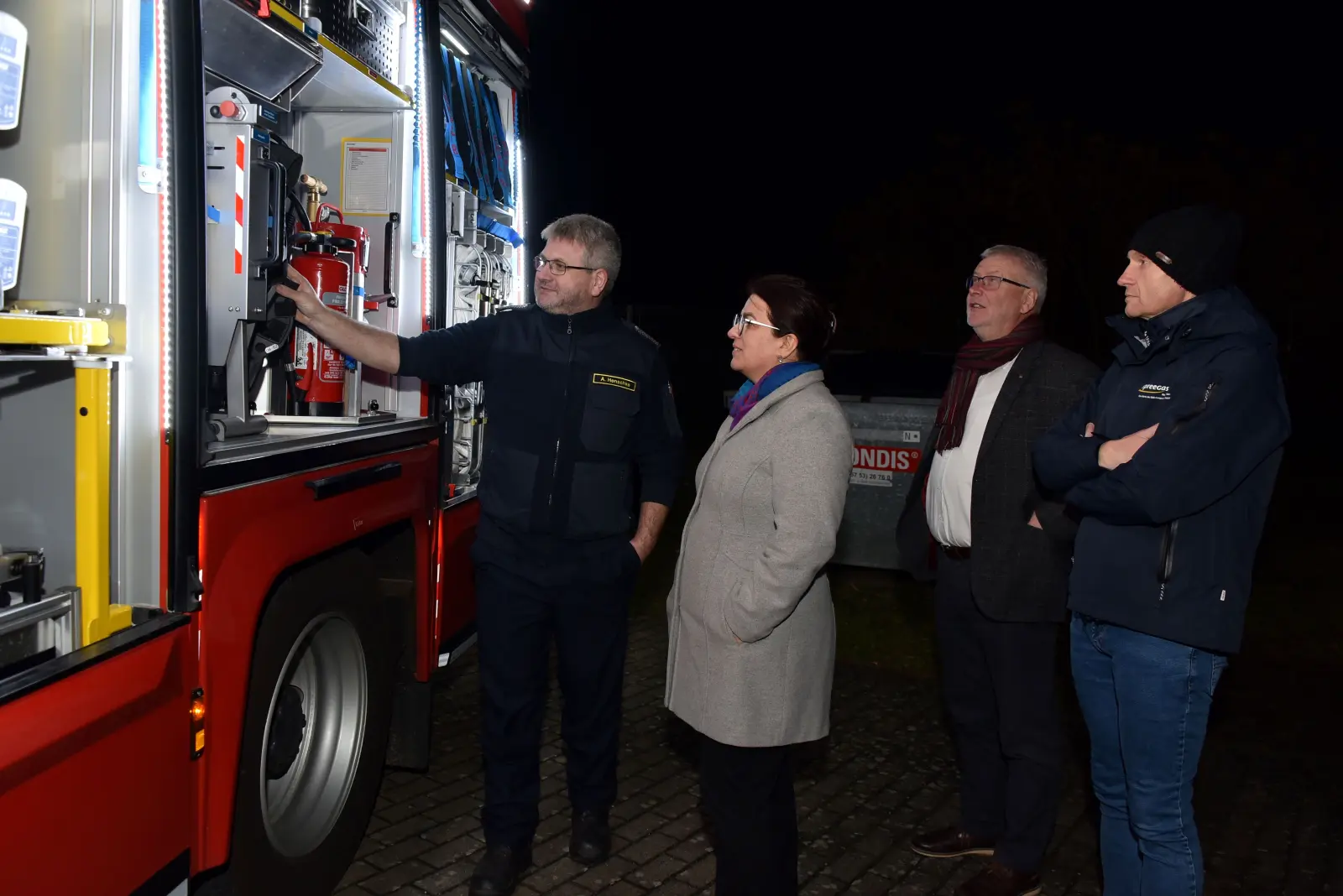 Herr Alexander Henschke (v.li.n.re) erklärt EMB-Geschäftsführerin Kathrin Jung die Ausstattung des neuen Löschfahrzeugs..