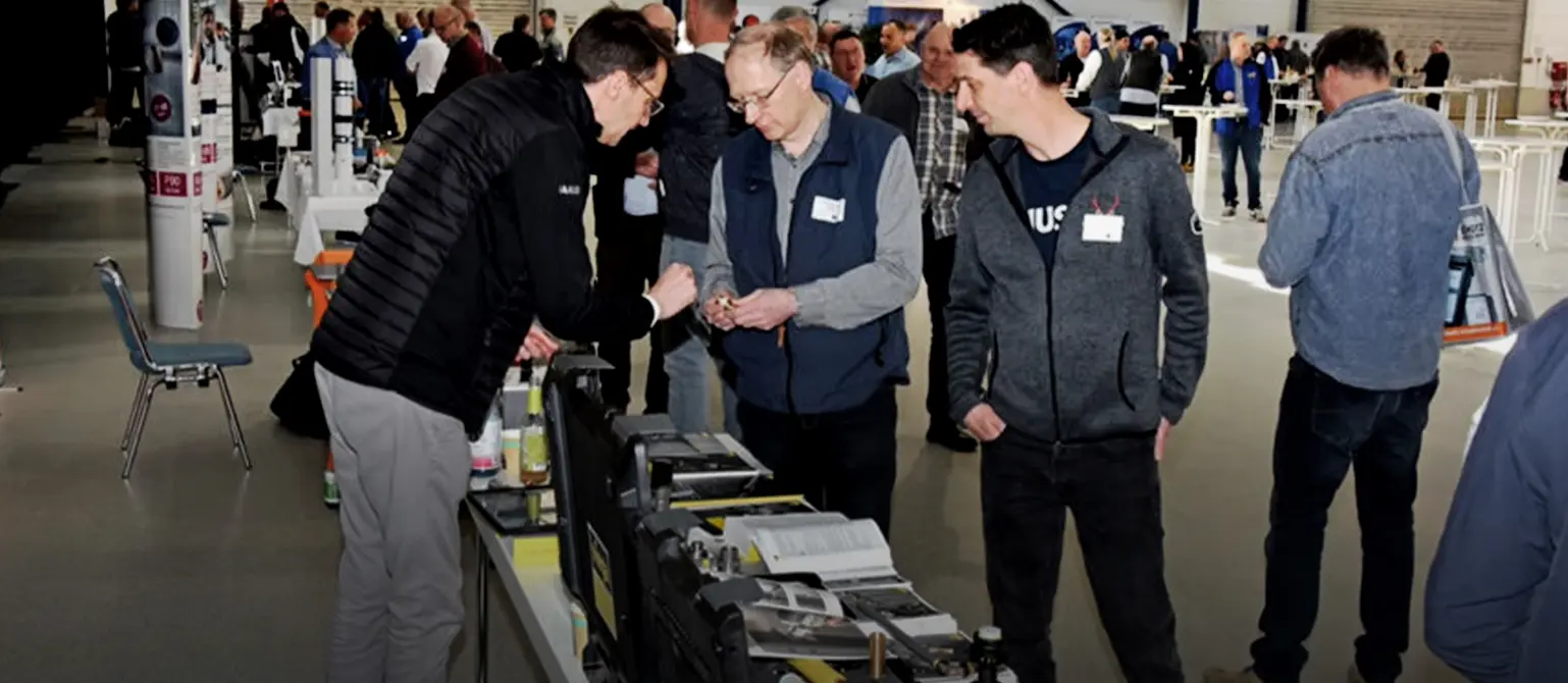 Menschen schauen sich an Ständen verschiedene Produkte an und reden darüber